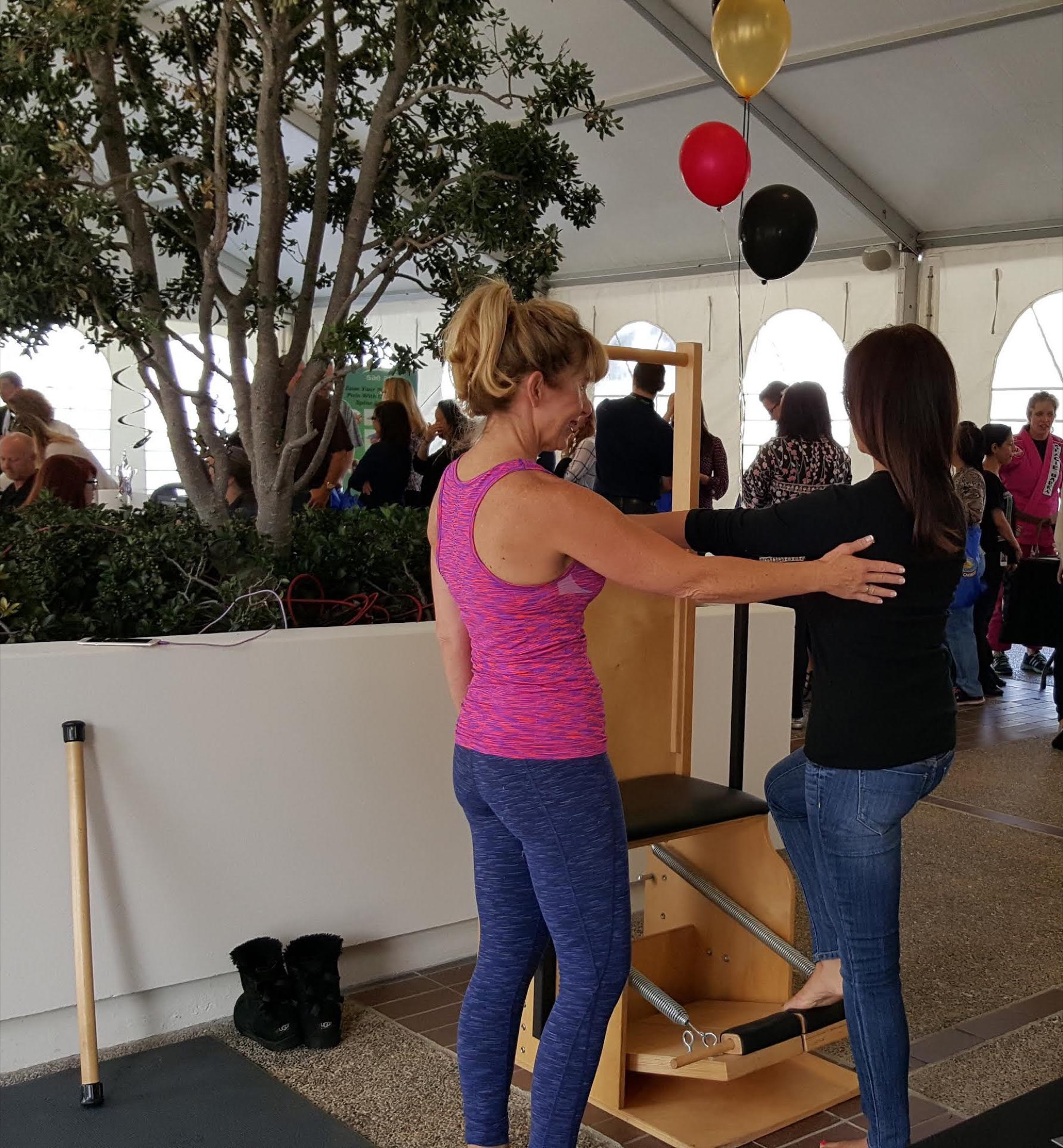 An employee using a pilates reformer during an onsite session