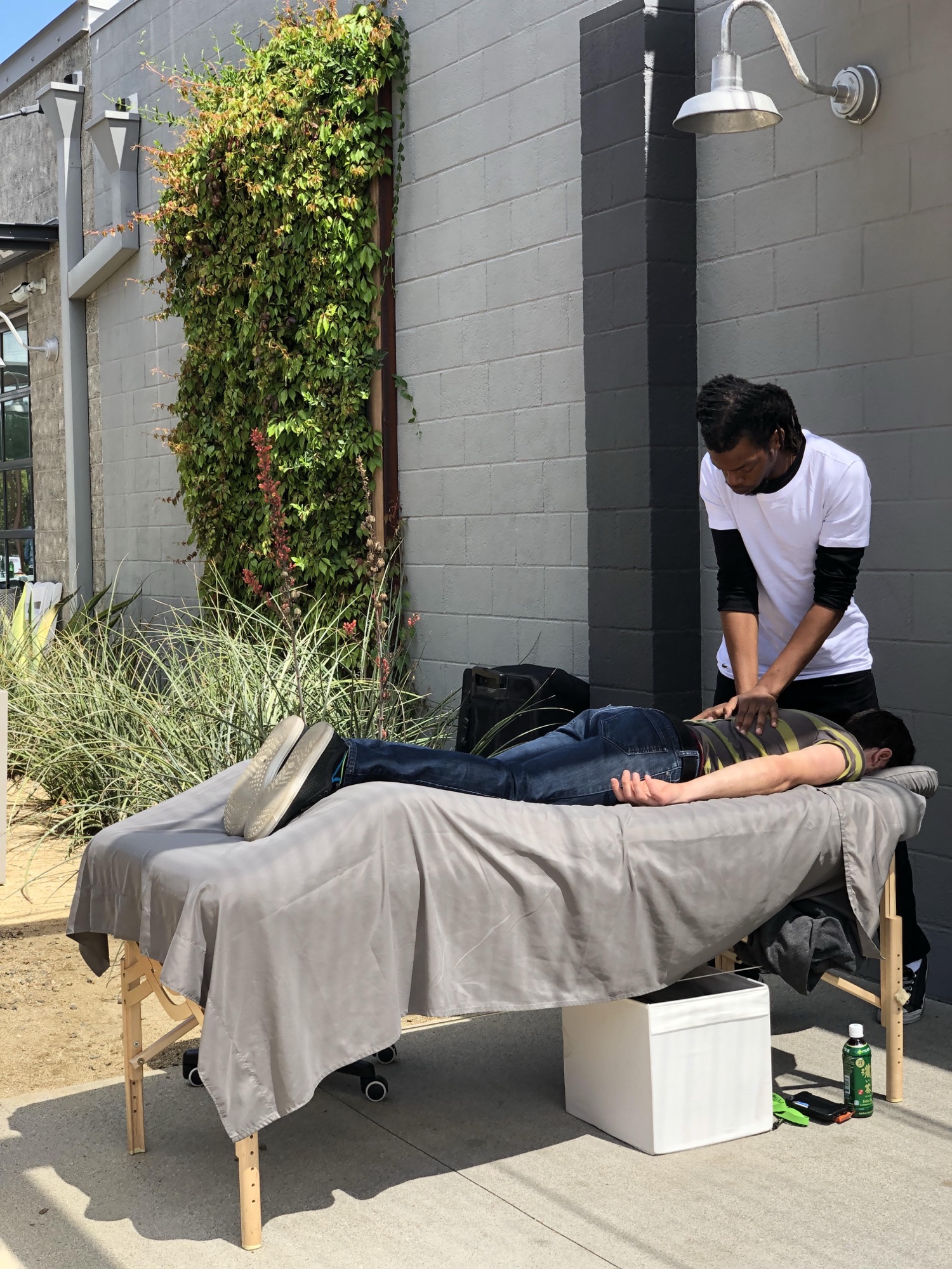 An outdoor chair and table massage station at a corporate wellness event